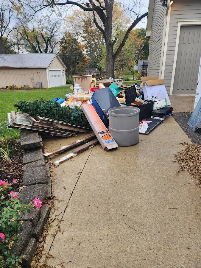 Dumpster being loaded with debris for 12 Yard Dumpster Rental in Ellington